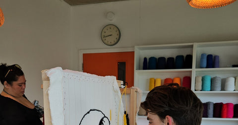 Beginner learning rug tufting at a workshop in London at Craft Studio, using a tufting gun for the first time