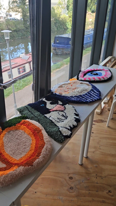 Finished handmade rugs displayed by the canal at Craft Studio London after a private tufting workshop.